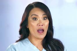 Woman in medical scrubs with a surprised expression