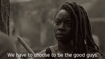Michonee with a determined expression, holding a weapon, with the subtitle, &quot;We have to choose to be the good guys&quot; in a scene from The Walking Dead