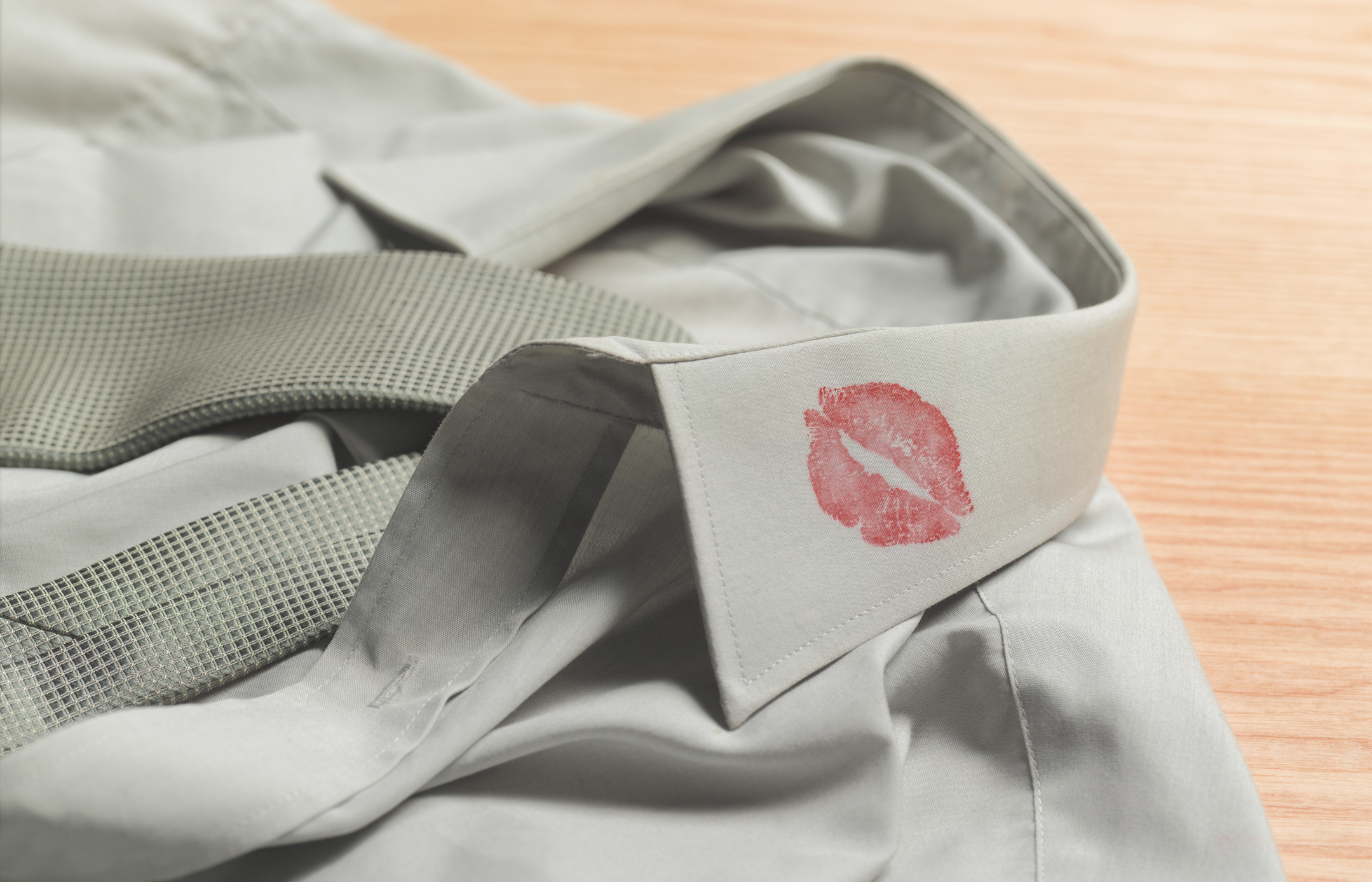 Gray shirt with a red lipstick mark on the collar
