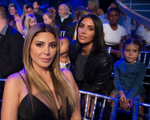 Kim Kardashian seated with Penelope Disick North West and Larsa Pippen