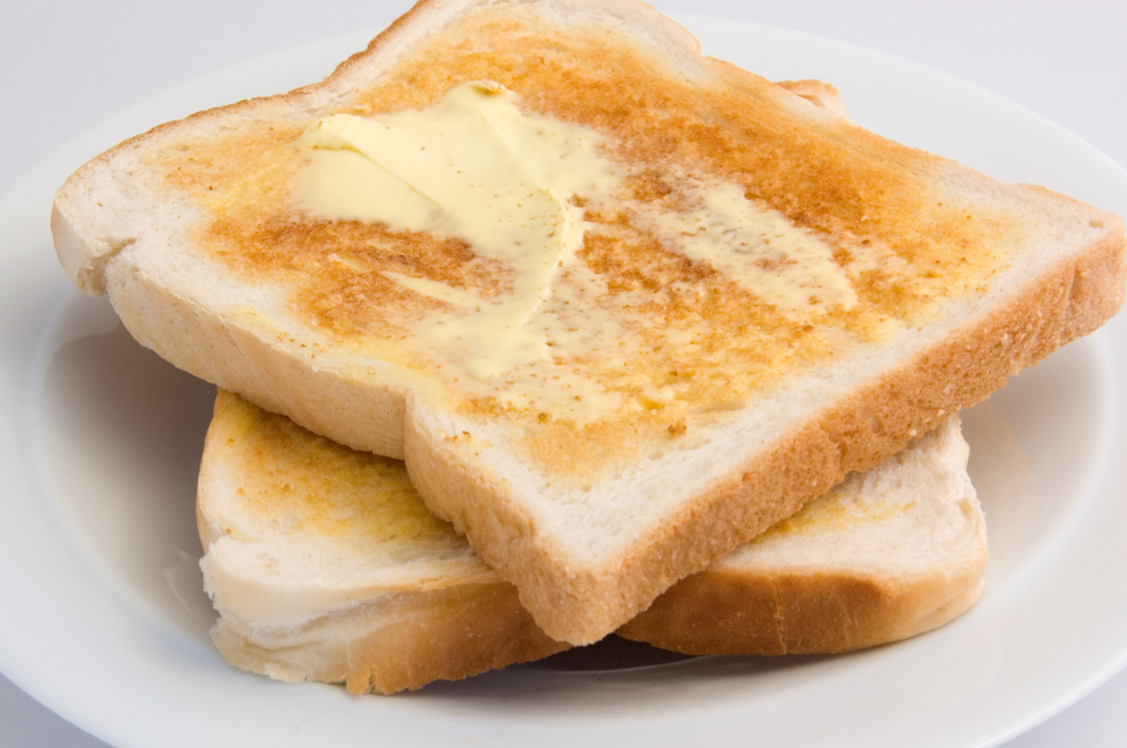 Two slices of toast with melting butter on a plate