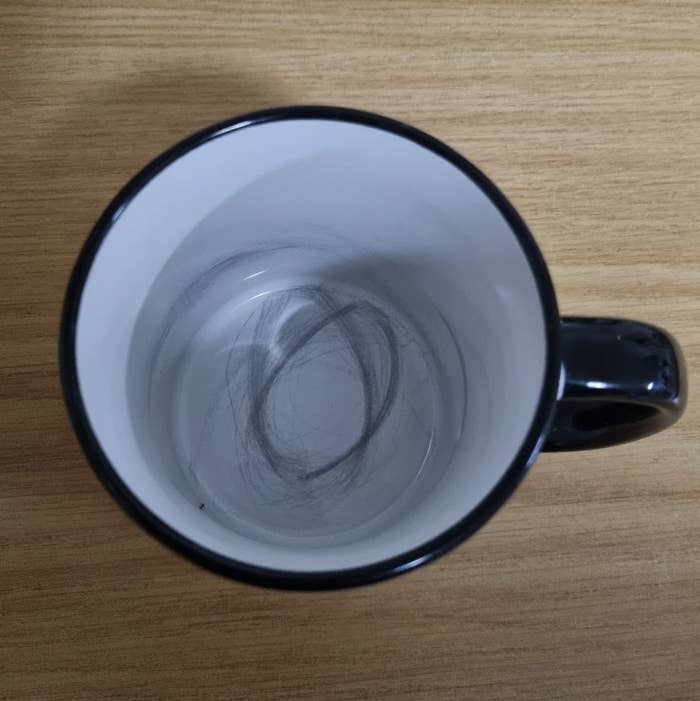 Top-down view of an empty coffee mug with a circular stain inside