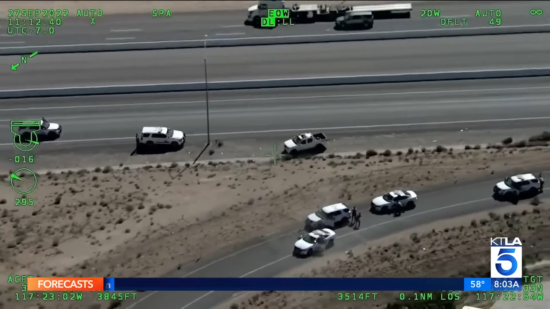 News chopper view of a high-speed chase with multiple police cars pursuing a vehicle on a highway