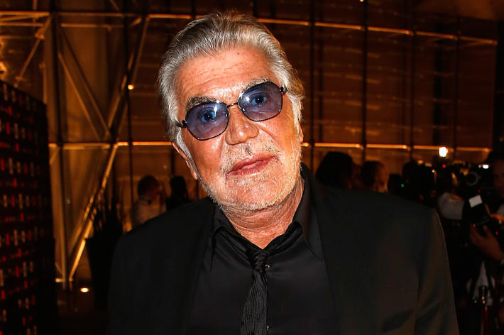 Man in black suit and sunglasses at an event