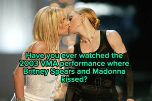 Britney Spears and Madonna onstage at the 2003 VMAs about to kiss