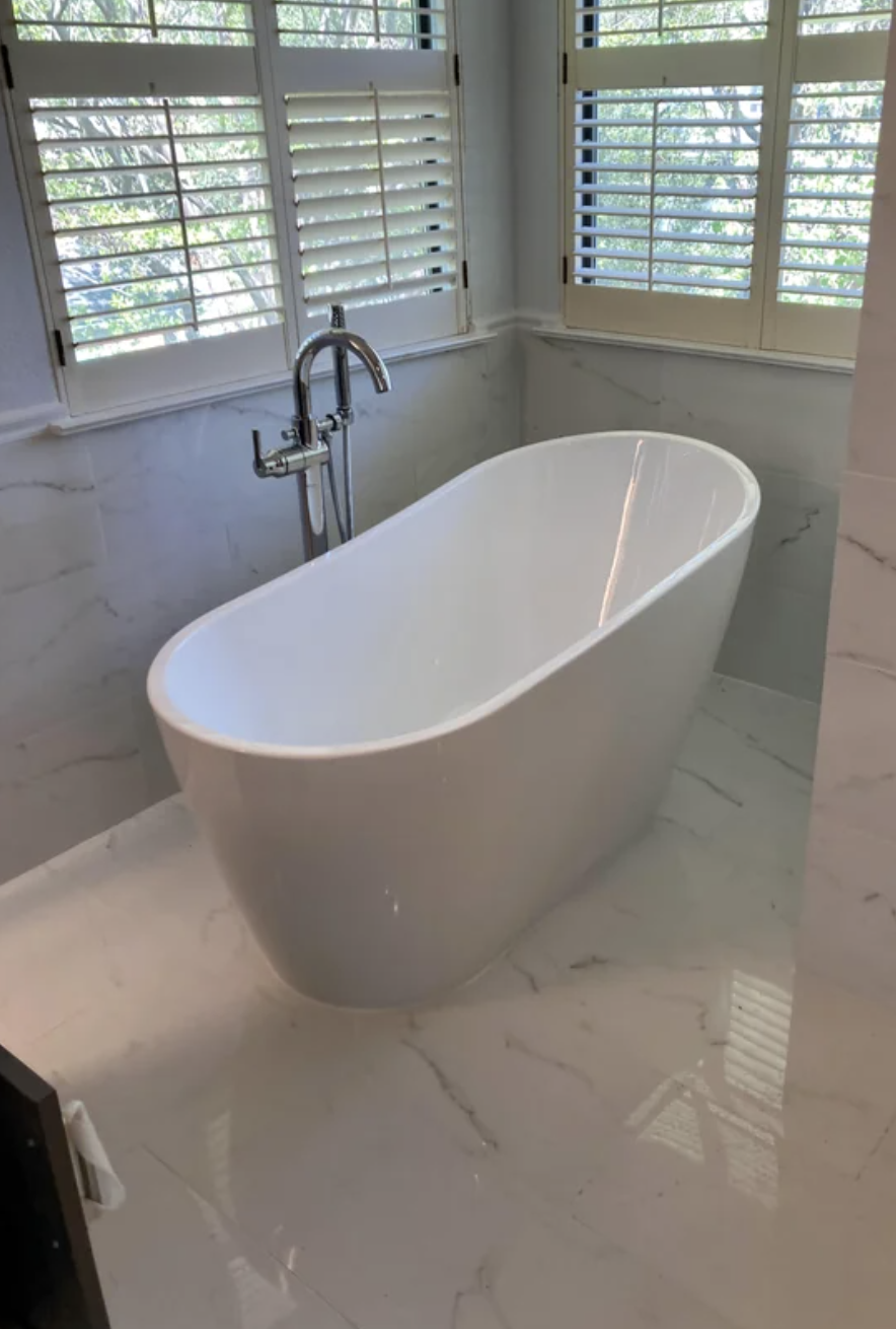 Bathroom with a freestanding bathtub near a window, with title "Yet another freestanding tub install."