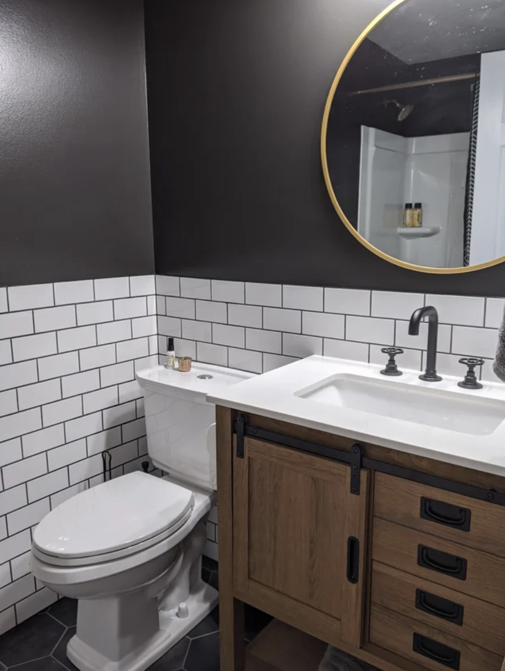 Modern styled bathroom with mirror, sink, and tiled walls
