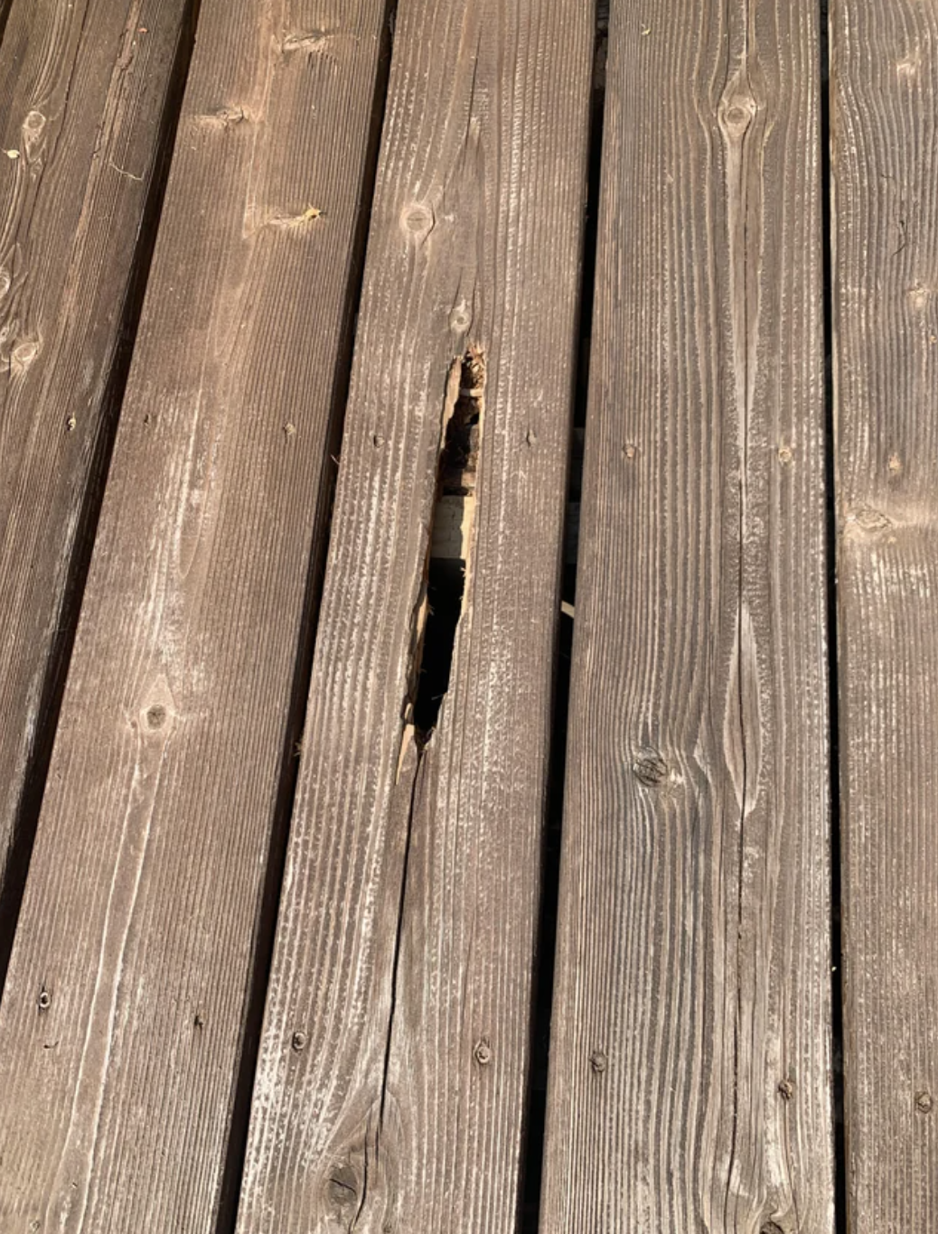 Damaged wooden deck with a prominent crack