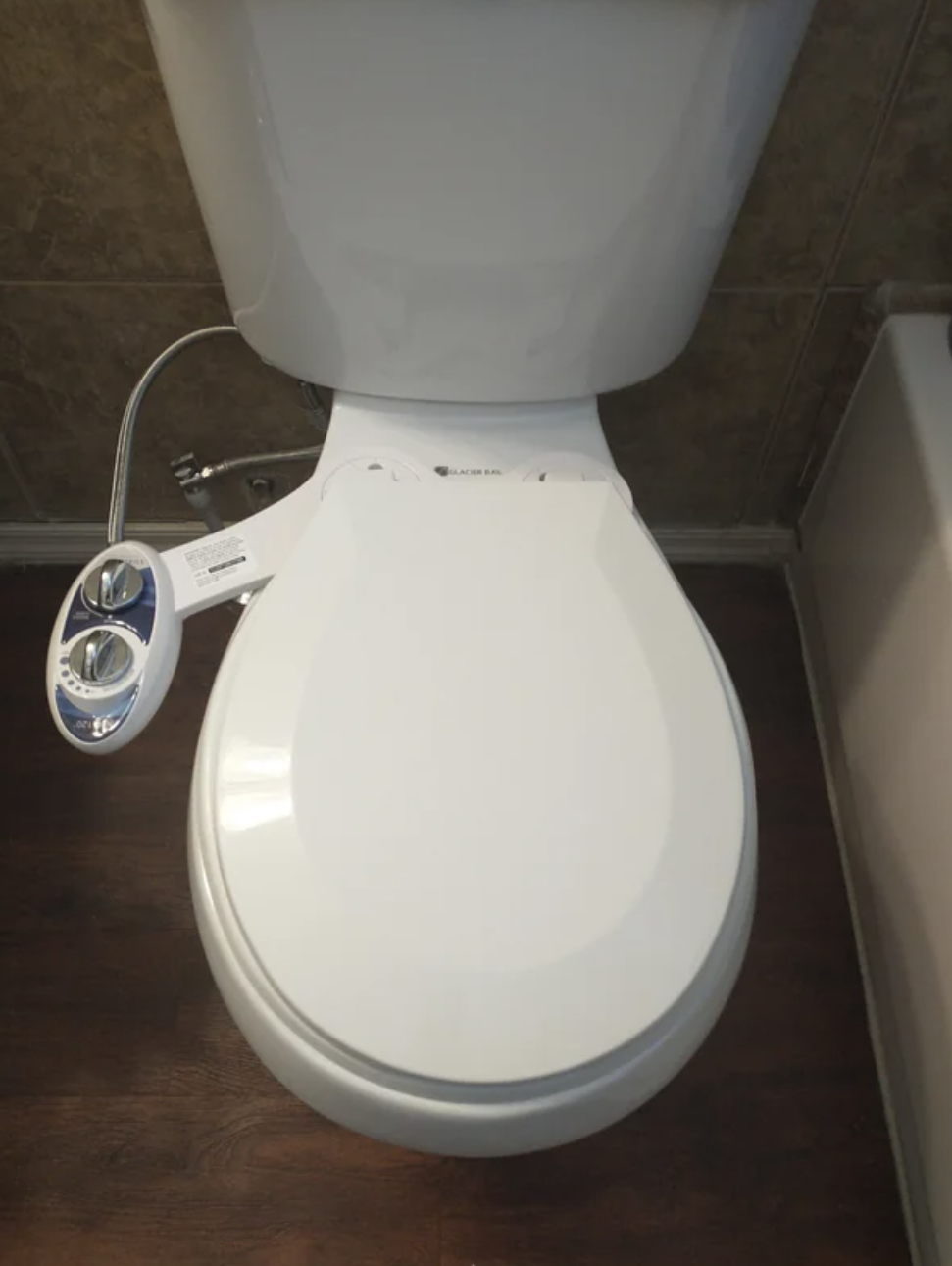 Toilet with attached bidet featuring a self-cleaning nozzle