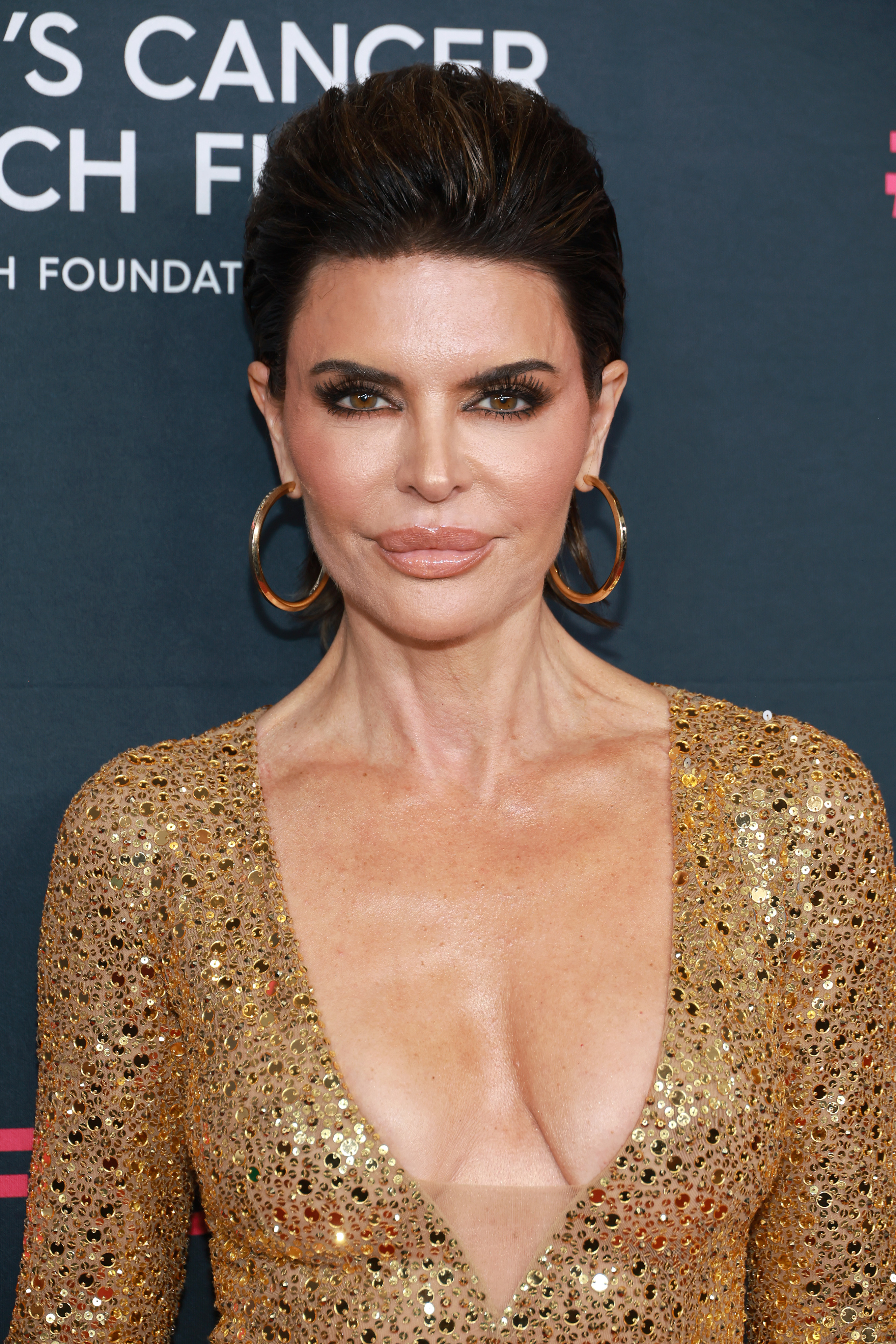 Lisa Rinna wearing a sequined dress with plunging neckline at an event