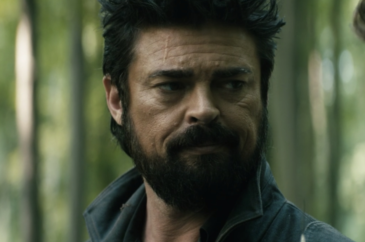 Bearded man with intense expression in a forest, from a TV show scene