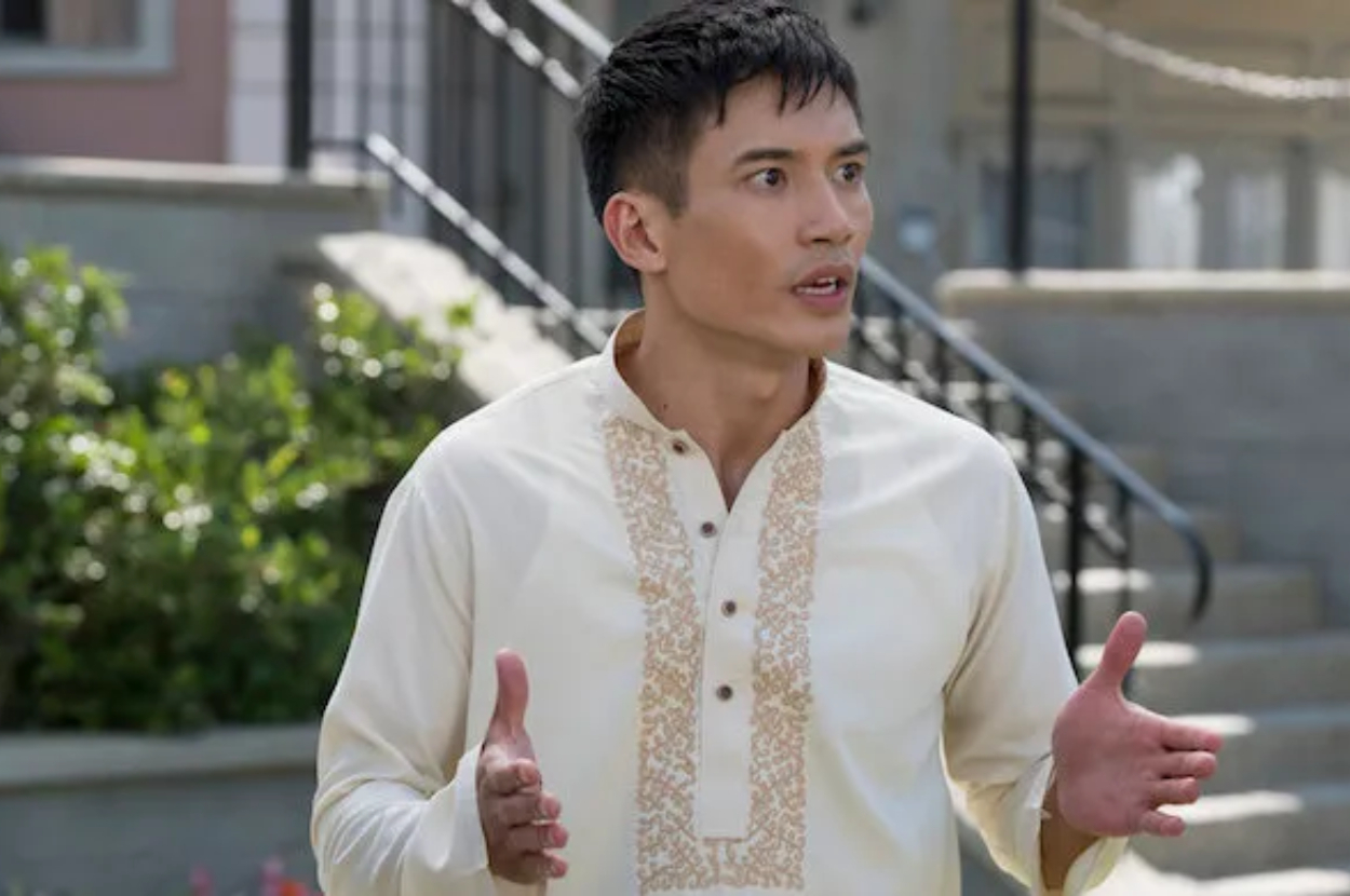 Actor in traditional barong shirt gesturing during a scene