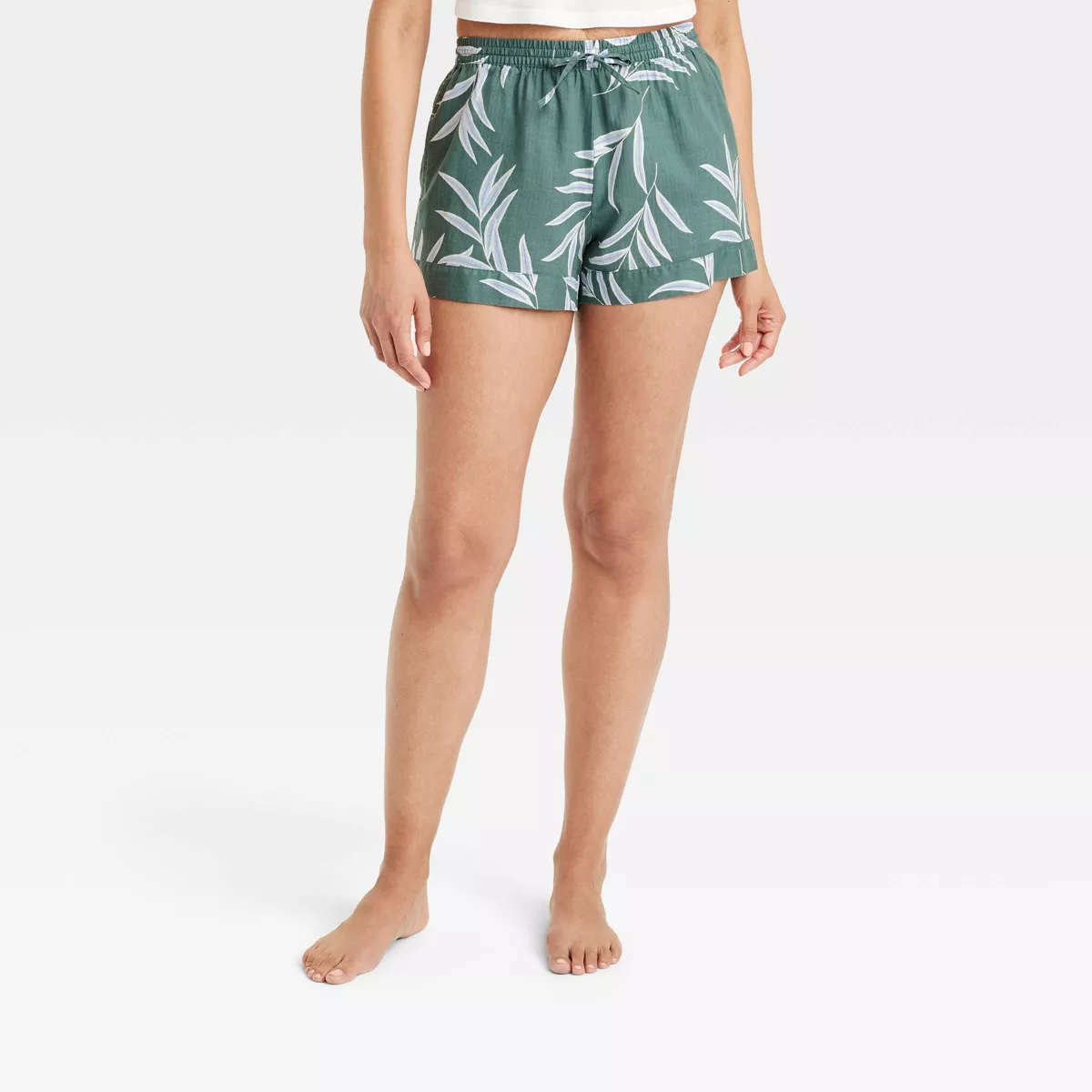 a model wearing the shorts in green