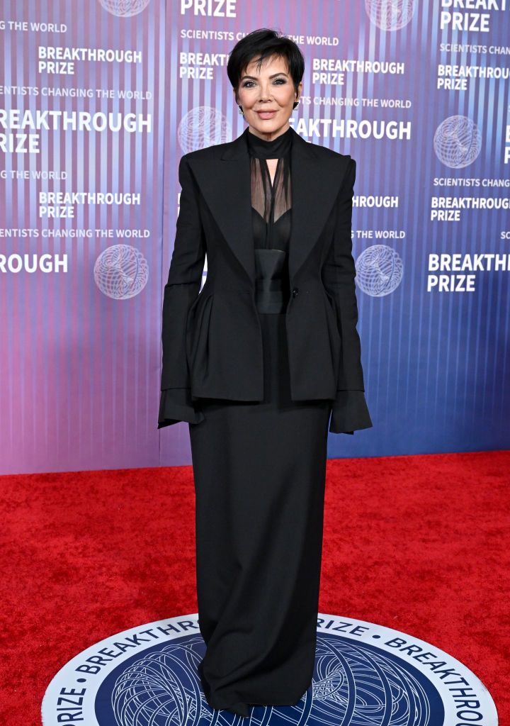 Kris Jenner in a black suit with sheer detailing, posing at the Breakthrough Prize event