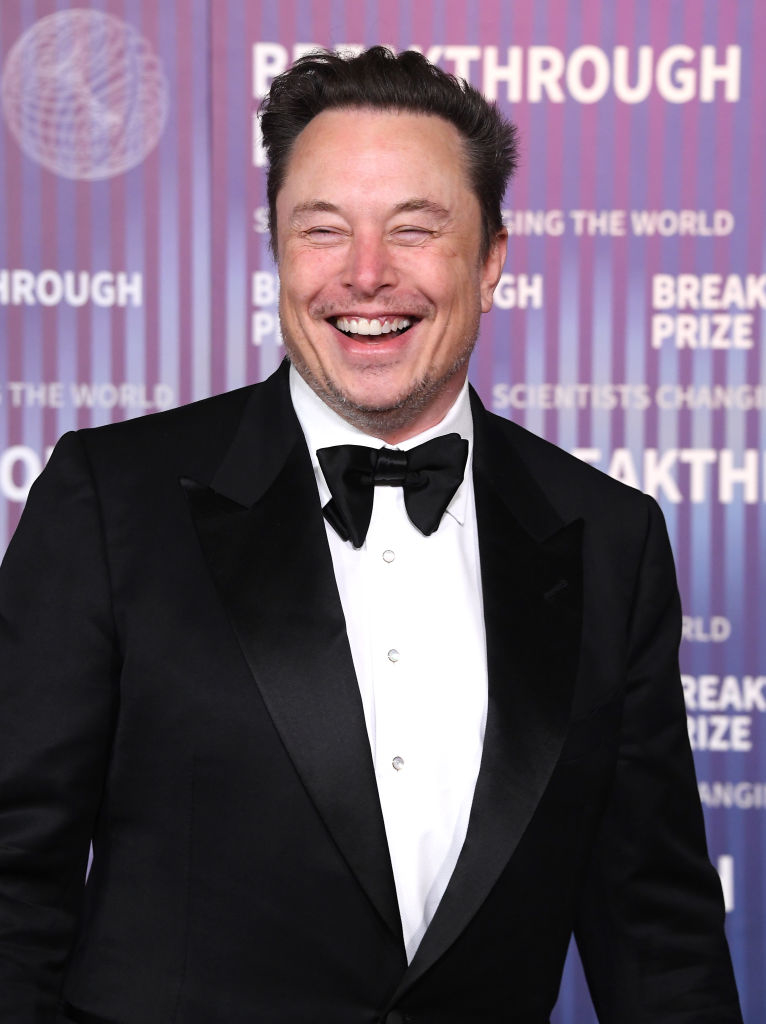 Elon Musk in a black tuxedo with a bowtie, smiling at the Breakthrough Prize event