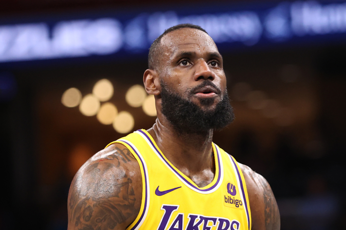 LeBron James in a Lakers basketball uniform on the court focused during a game