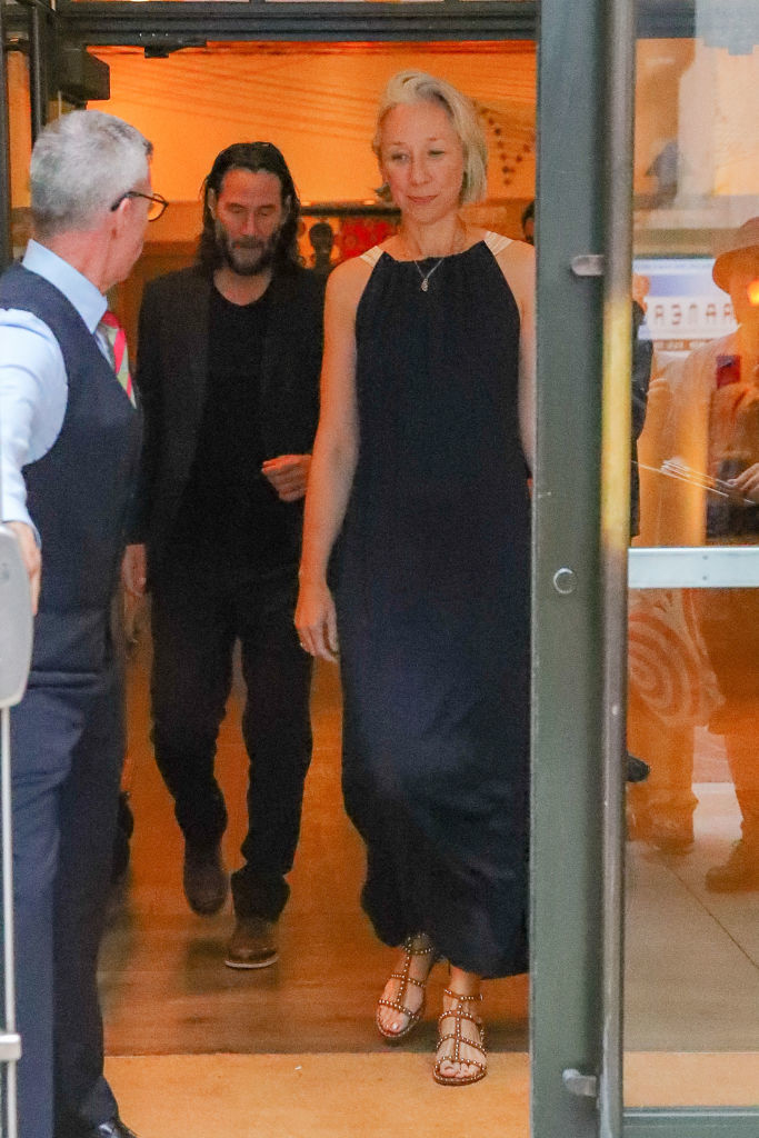 Keanu Reeves and Alexandra Grant leaving a building