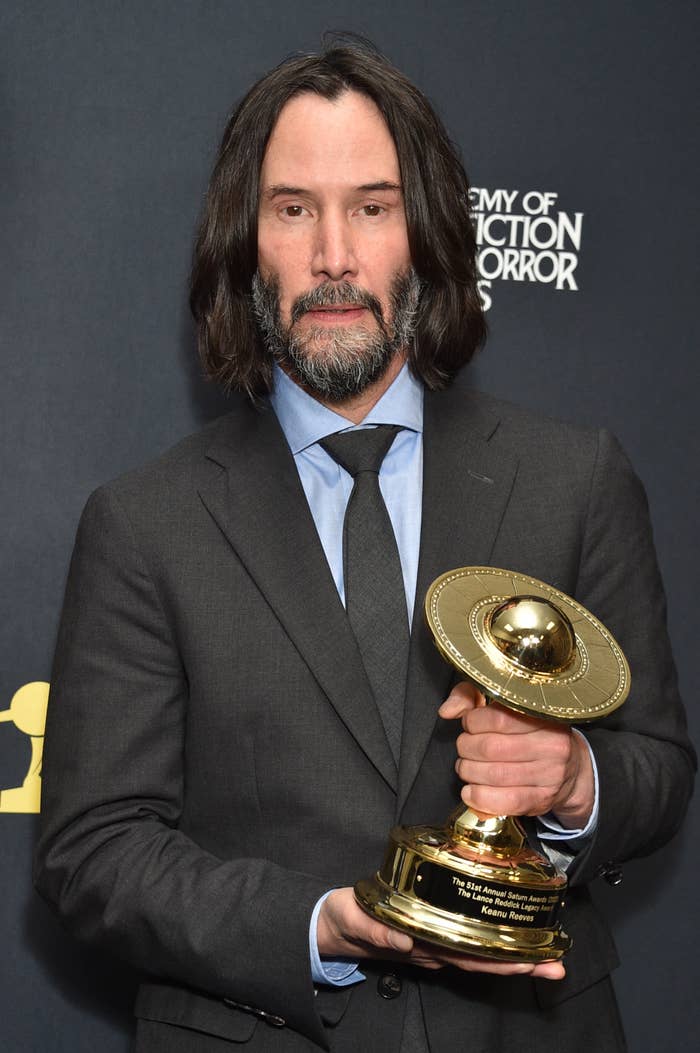 Keanu Reeves holding an award