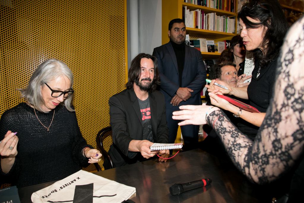Alexandra Grant and Keanu Reeves signing autographs