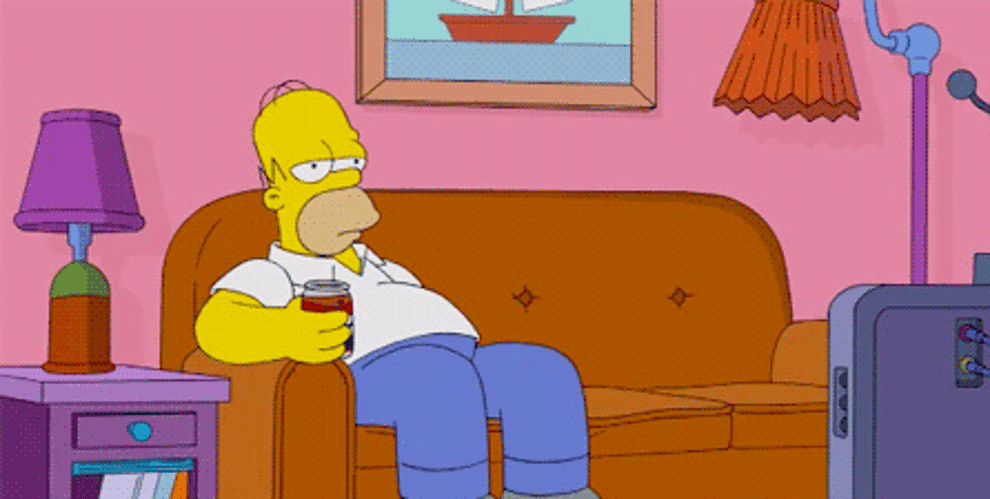Homer Simpson sitting on couch, drinking a can of soda, with a remote control in the other hand, looking uninterested