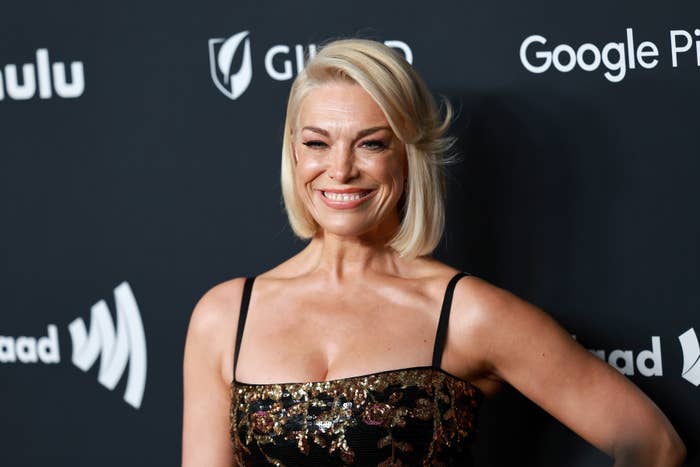 Hannah Waddingham smiles in a black and gold sequined dress at an event