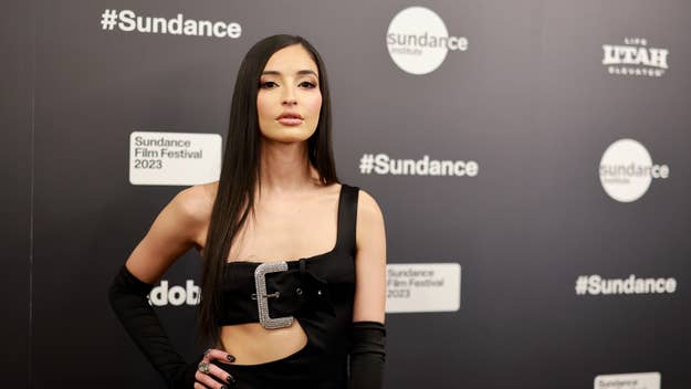 Woman in a black sleeveless top with a unique buckle detail, posing at Sundance Film Festival