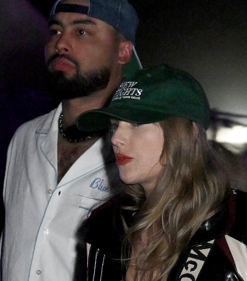 Taylor in a ballcap with the &quot;New Heights&quot; logo