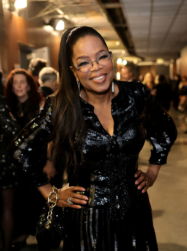 Oprah Winfrey in a sparkling black outfit, smiling at an event