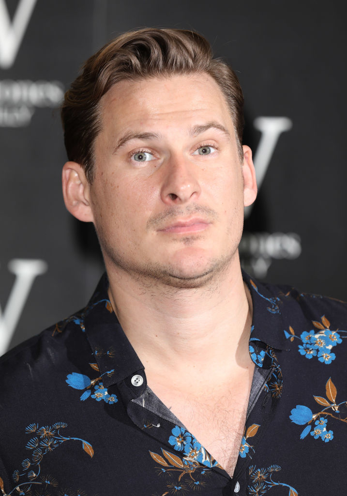 Lee Ryan in a floral shirt poses for a photo