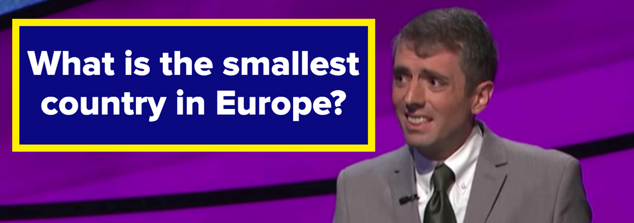 A game show contestant stands at the podium with a question displayed: "What is the smallest country in Europe?"