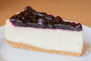 a slice of cheesecake with a blueberry topping
