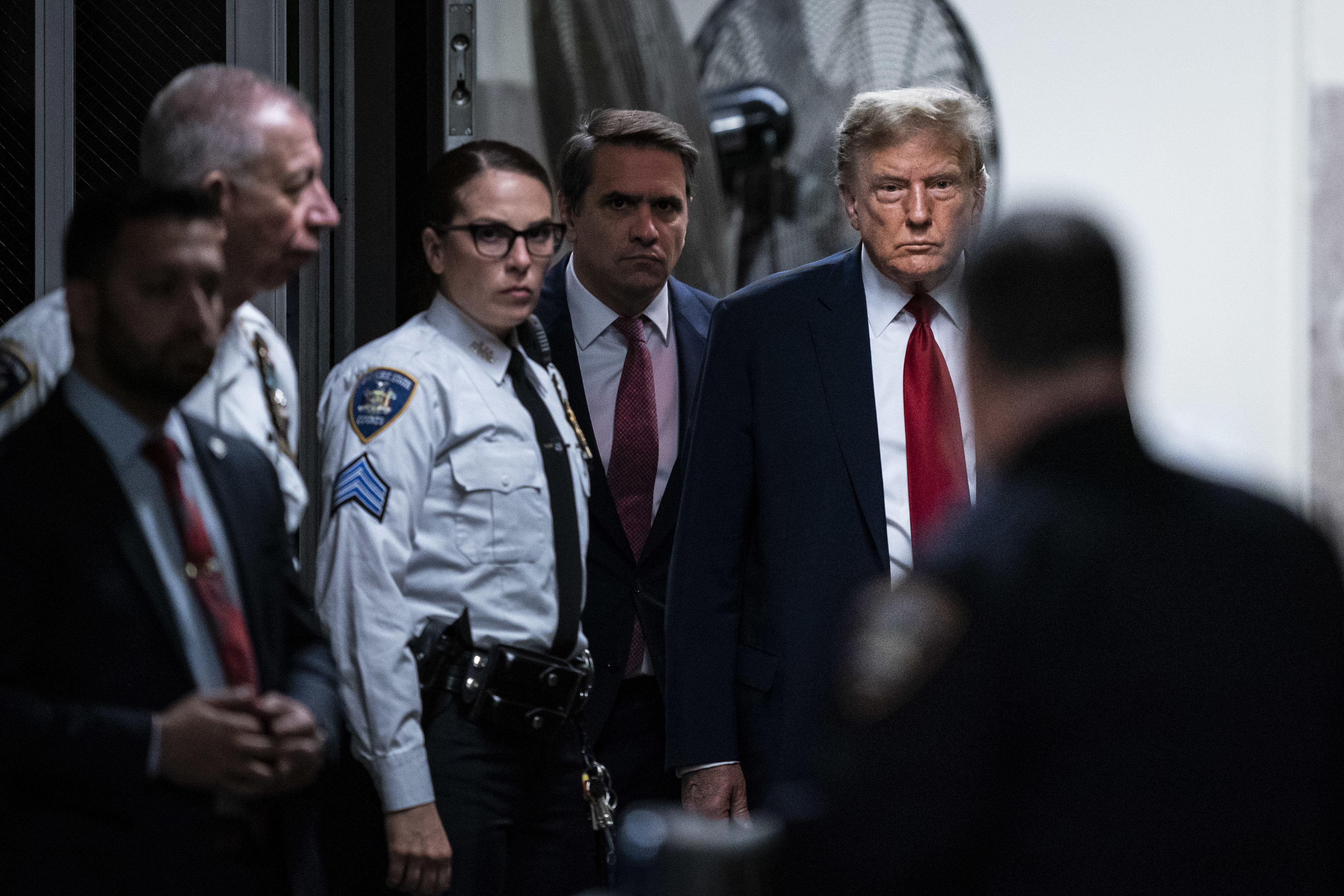 Trump walking with security behind him