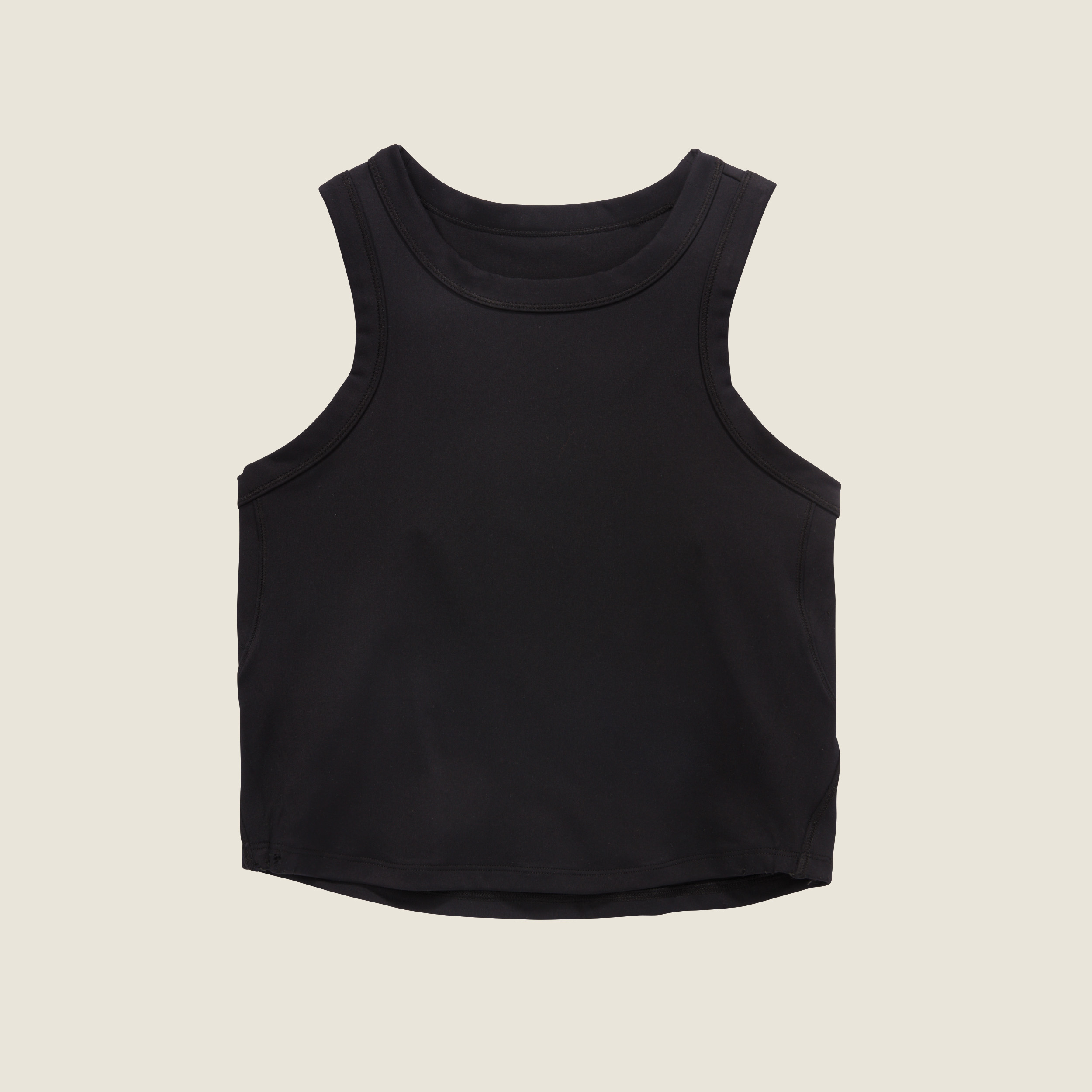 Black sleeveless crop top against a neutral background, part of an advertised clothing line