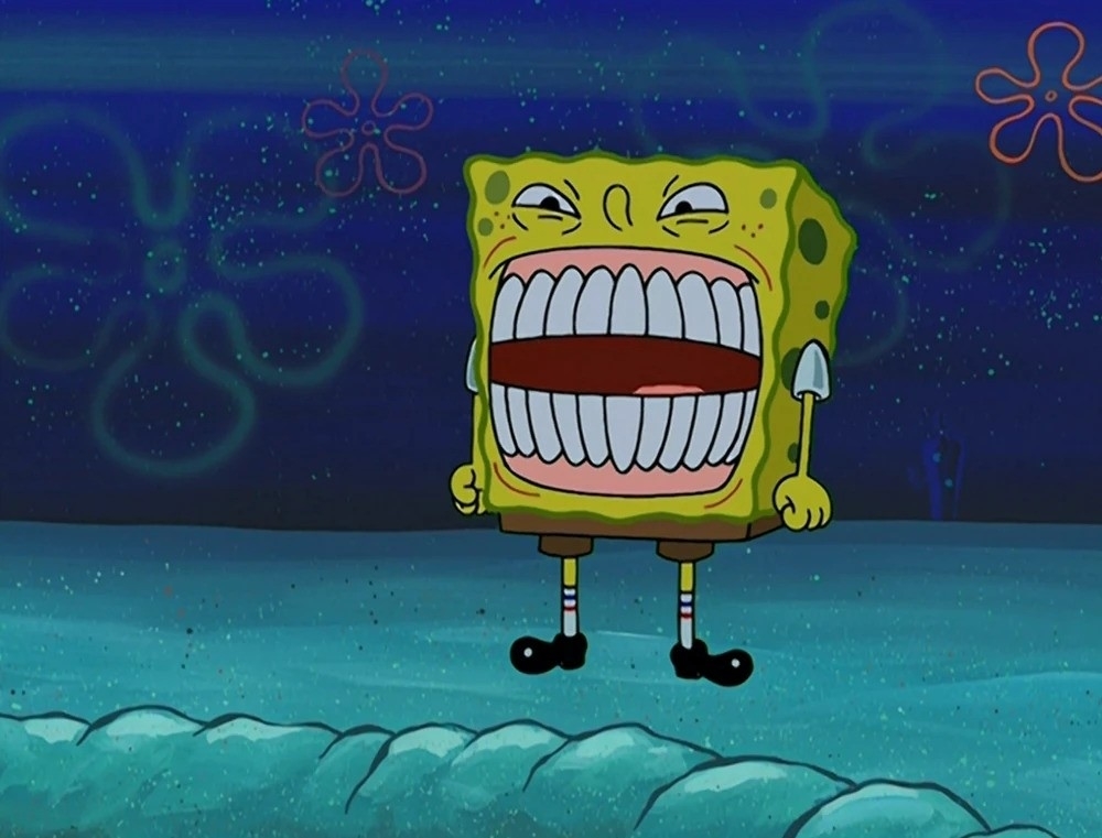 SpongeBob SquarePants stands angry with wide eyes at night under the sea