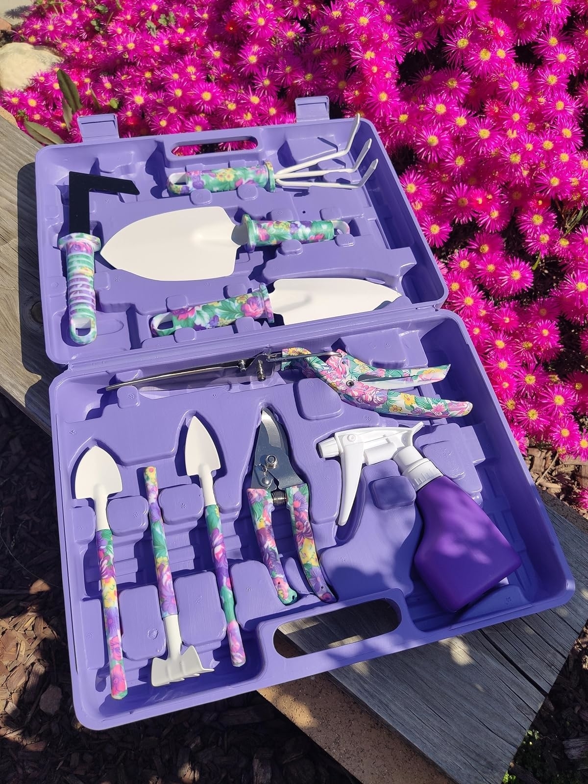 Gardening toolset with floral patterns, including trowels and pruners, displayed open on a floral background