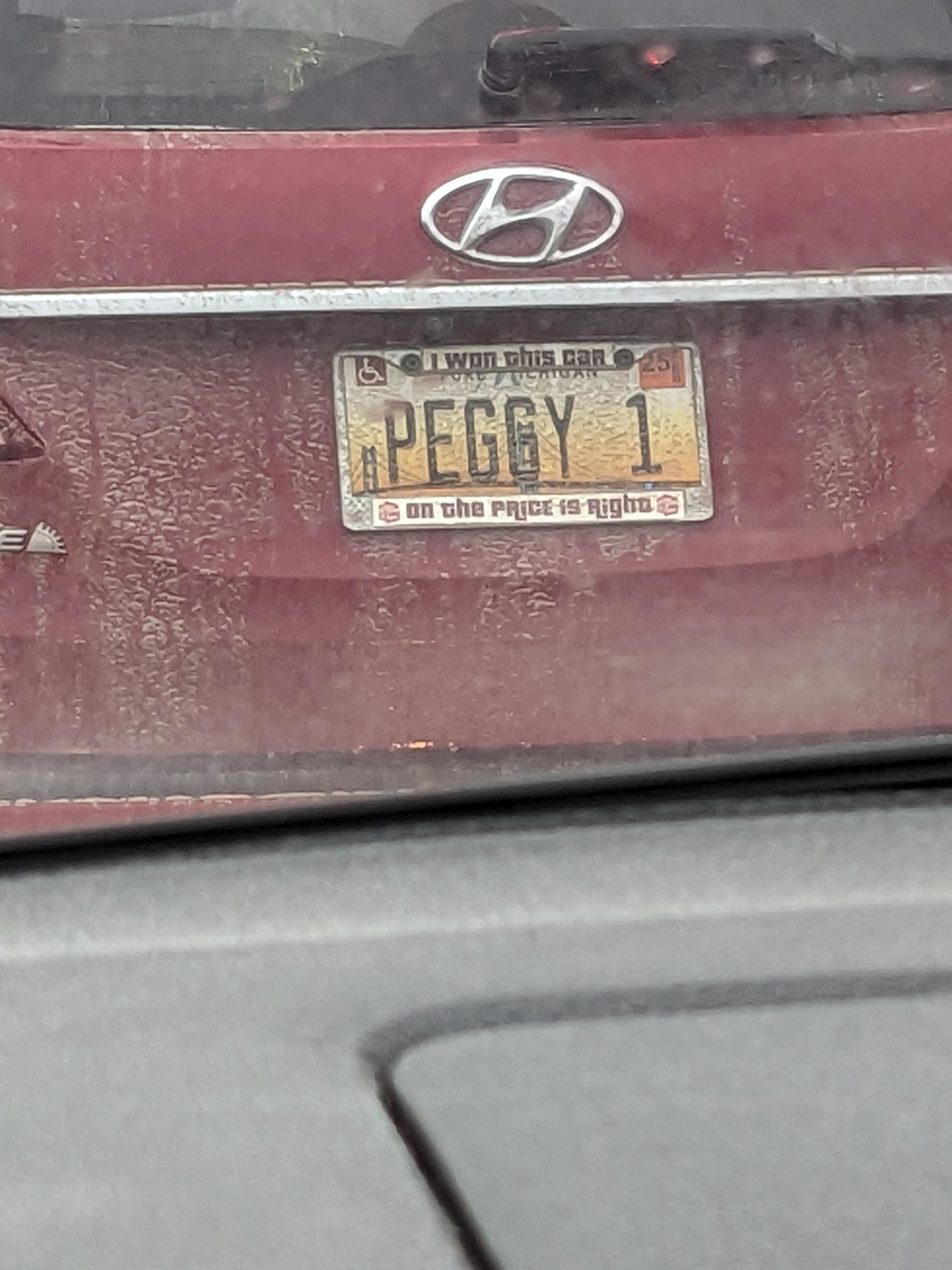 License plate reads &quot;PEGGY 1&quot; with a frame stating &quot;I won this car on The Price is Right.&quot; Vehicle appears dusty