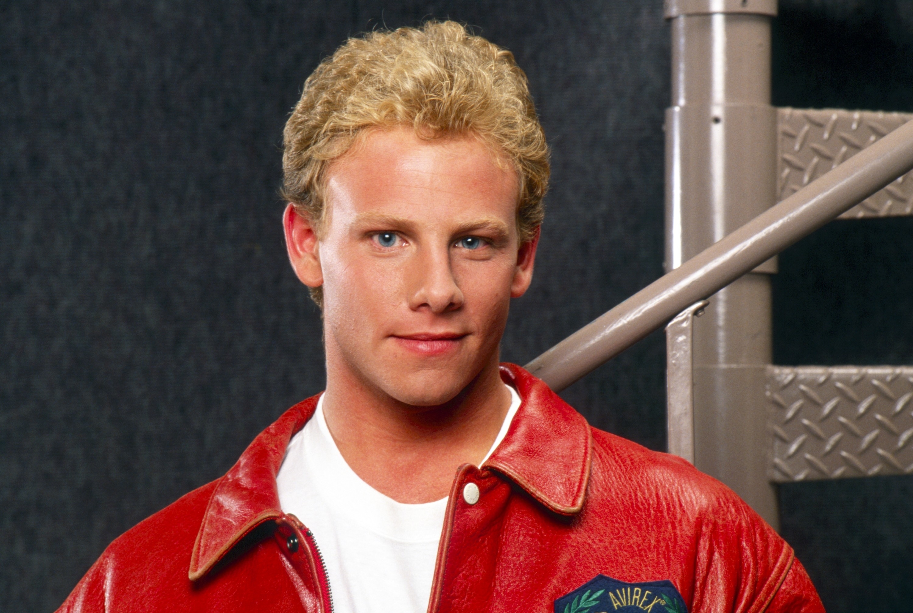 Actor in a red jacket with &quot;California University&quot; emblem, from a 90s TV show