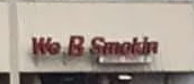 Sign reads &quot;We B Smokin&quot; on a wall