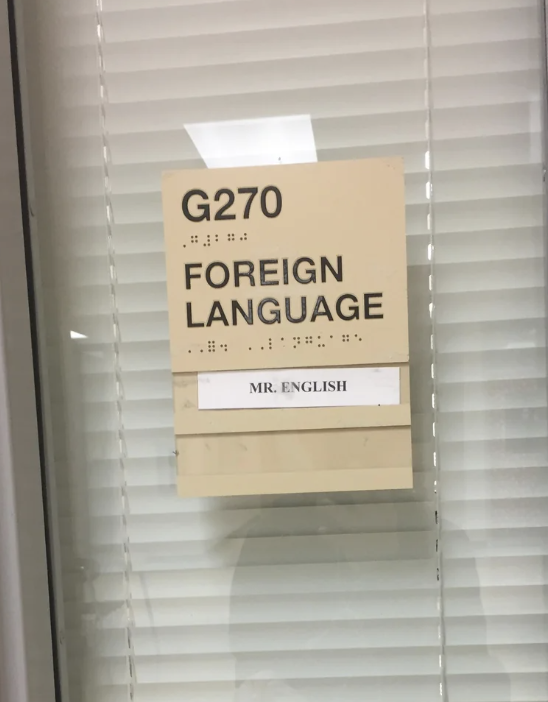 Sign on a door reading &quot;G270 FOREIGN LANGUAGE&quot; with &quot;MR. ENGLISH&quot; below in Braille and text