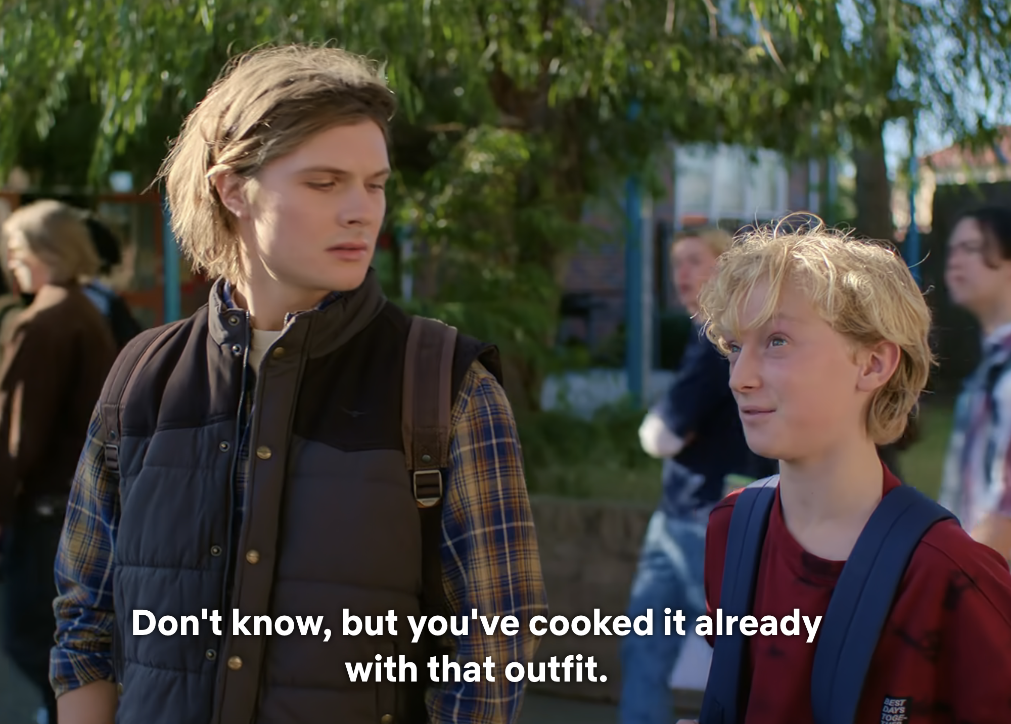 Two characters from a TV show, one with a backpack, engaging in conversation with subtitles displayed