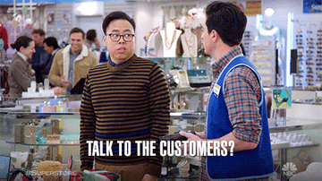 Two characters from the show Superstore are in conversation in a retail setting