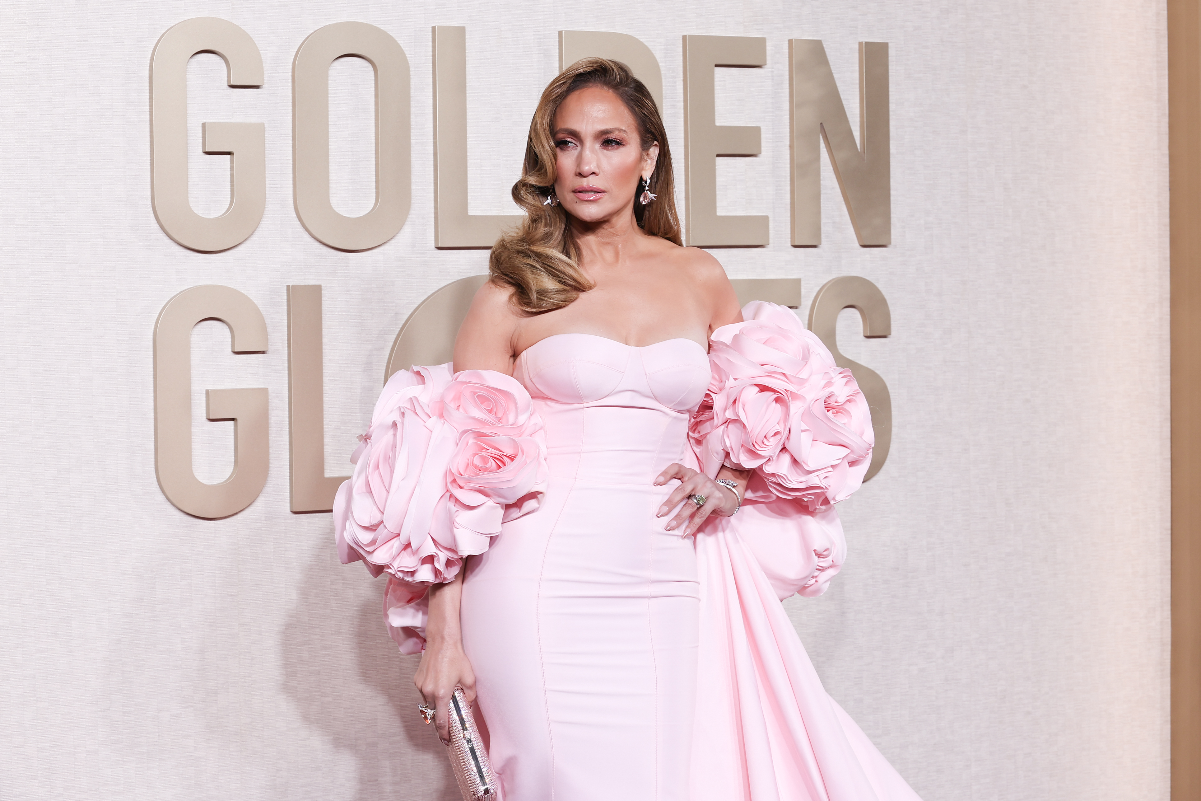 Jennifer Lopez in a strapless gown with large floral embellishments on the sleeves at the Golden Globes