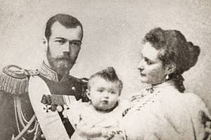 Vintage photo of a family with a man in military attire, a woman in a dress, and a baby