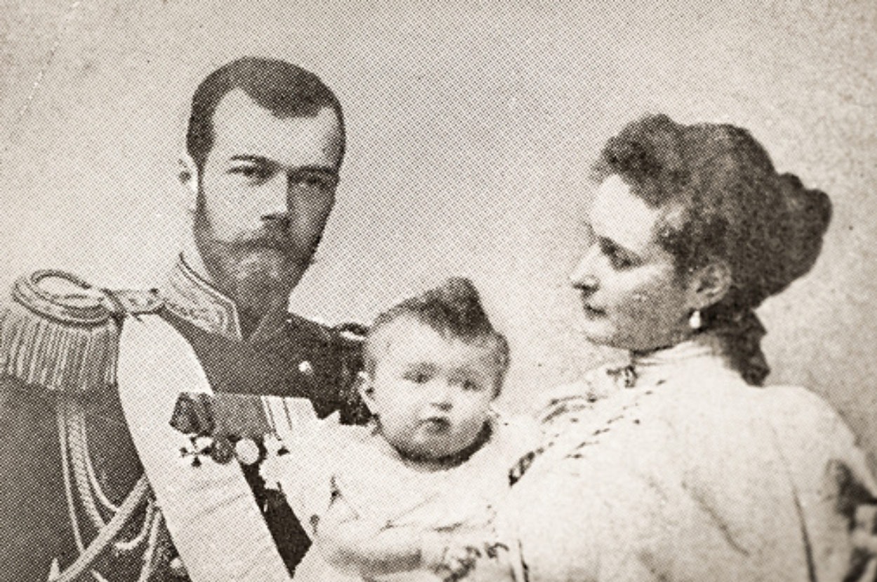 Vintage photo of a family with a man in military attire, a woman in a dress, and a baby