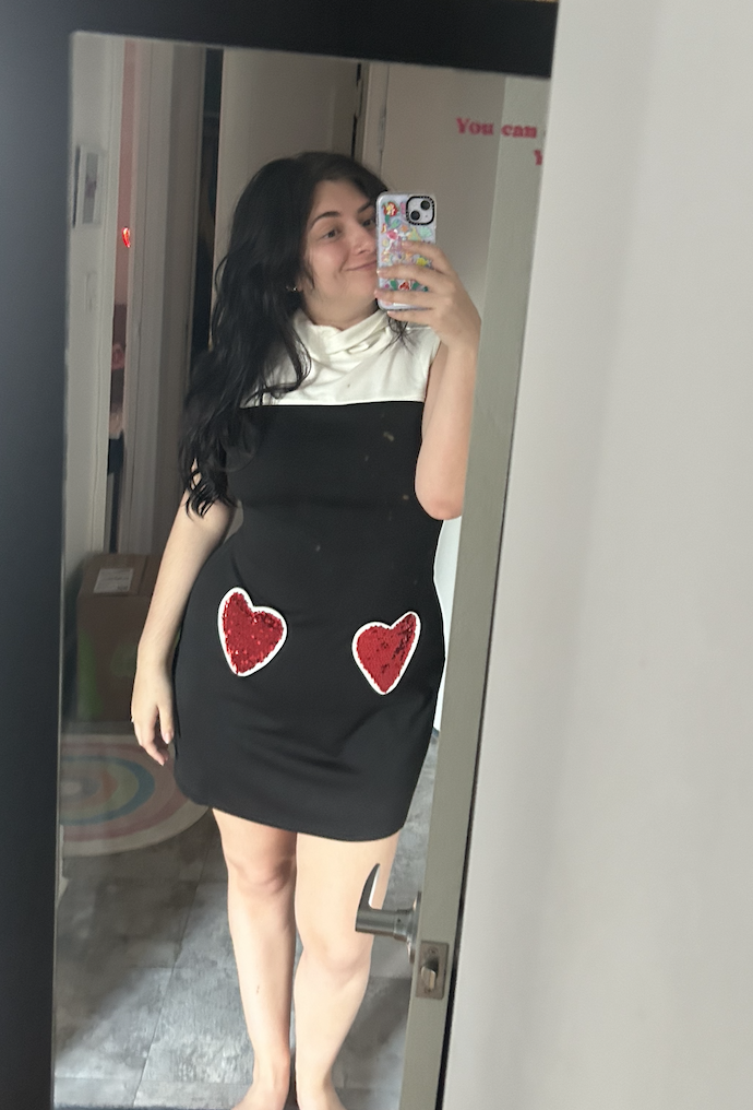 Woman in a dress with heart details taking a mirror selfie