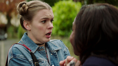 Two women in a tense conversation, one with a surprised expression, from a TV show scene