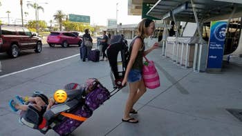 reviewer pulling luggage with child car seat attached