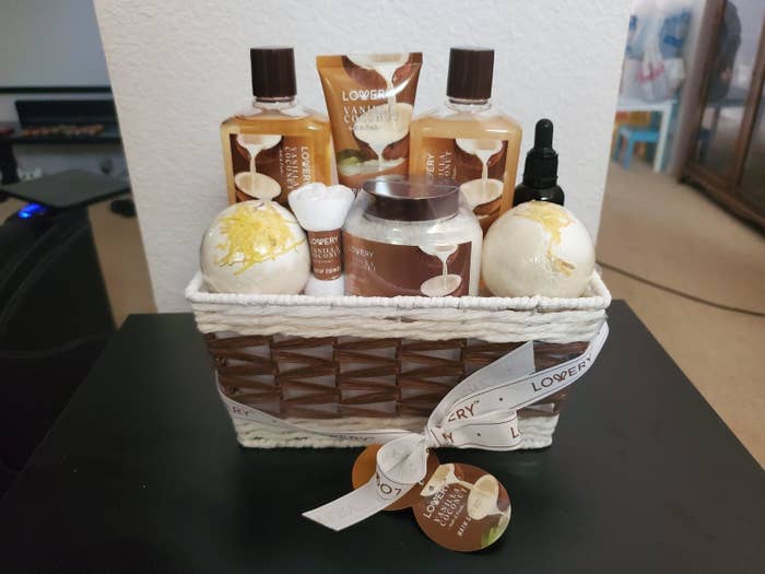 A gift basket with various bath products including lotions and bath bombs