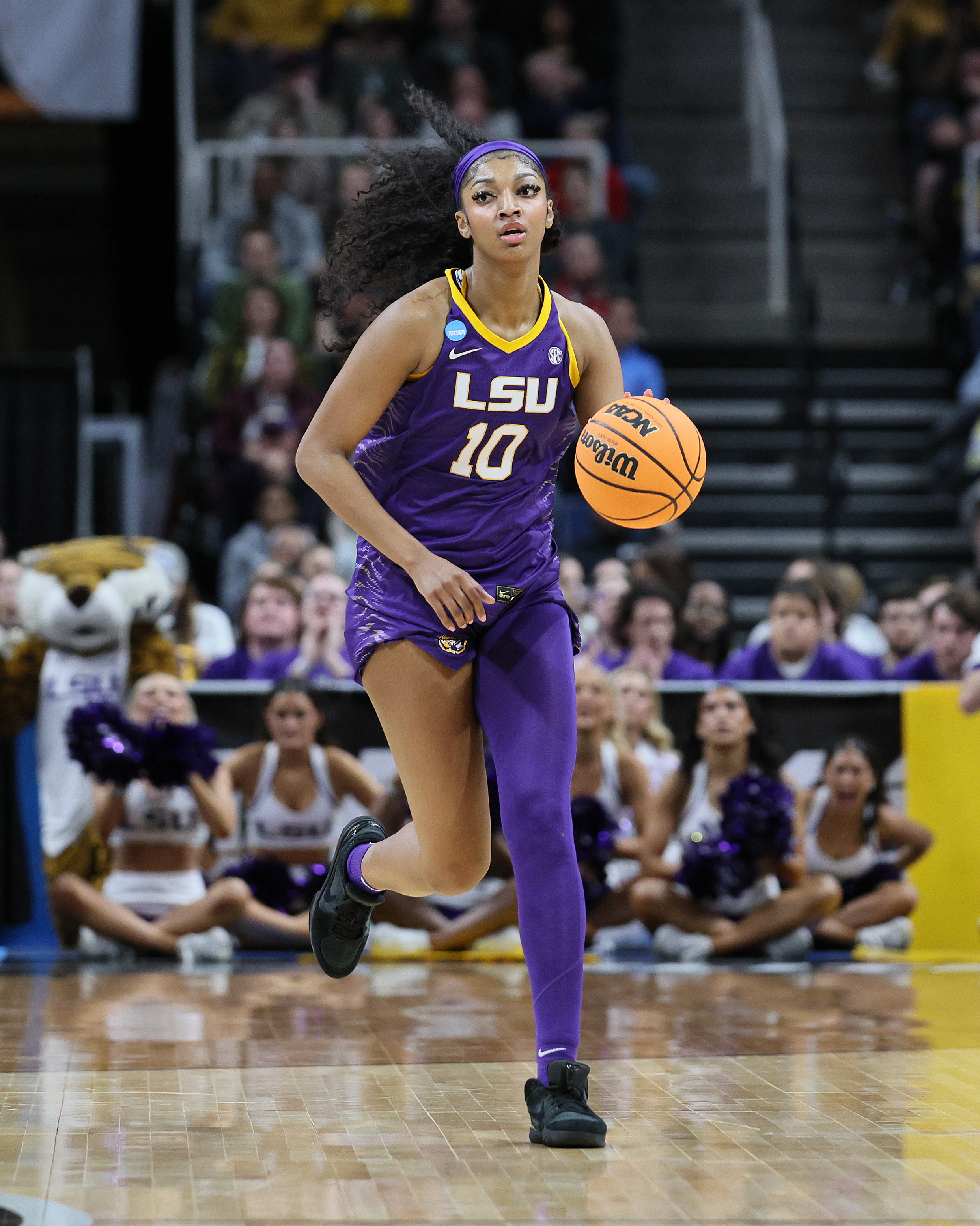 LSU women&#x27;s basketball player in action, dribbling the ball on the court during a game