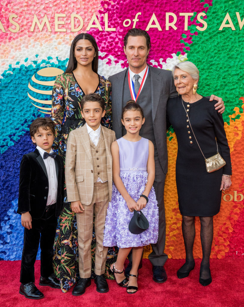 Family of five wearing formal attire posing together at an event